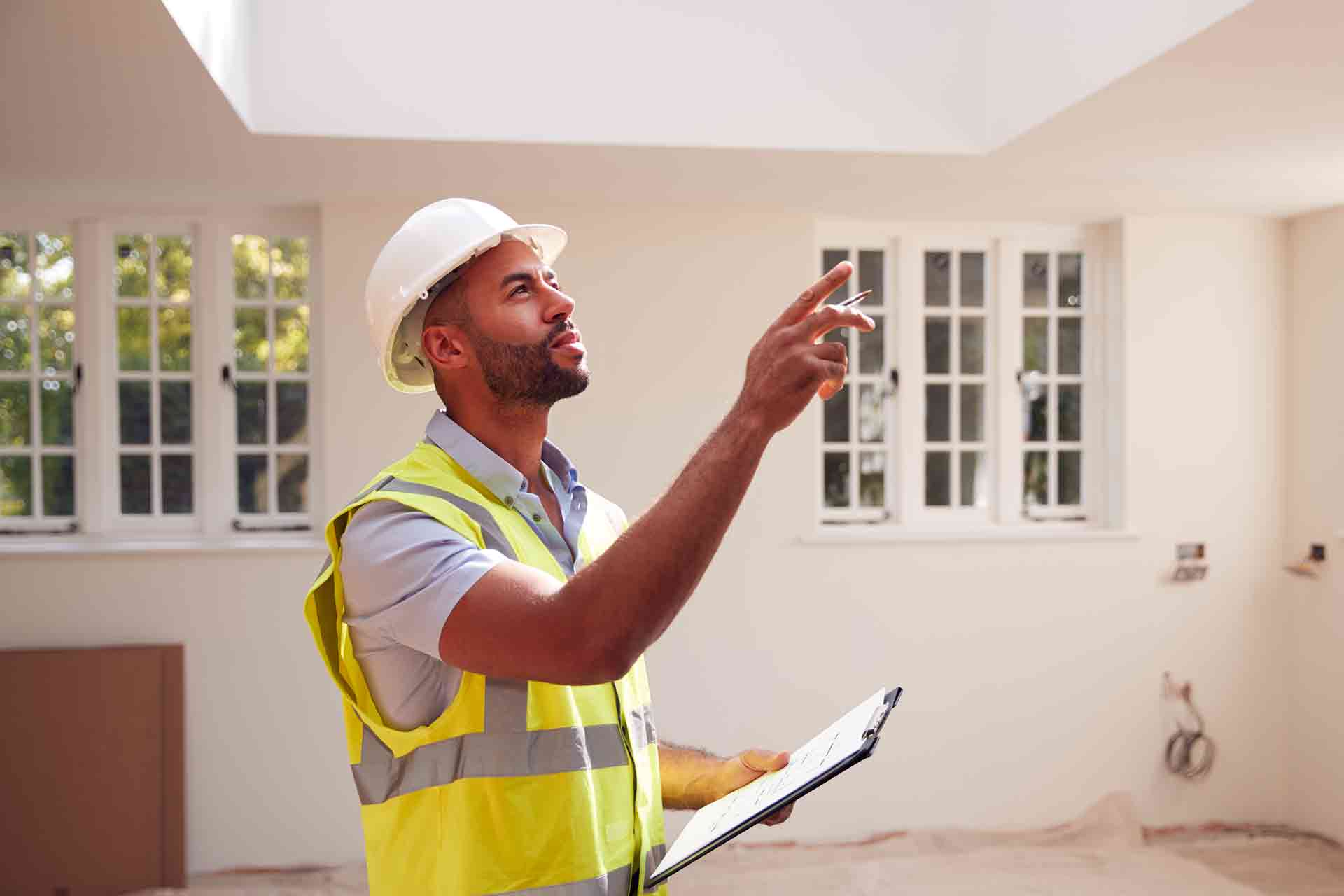 Third Party Wall Surveyors Warrington reviewing plans between two parties during a dispute